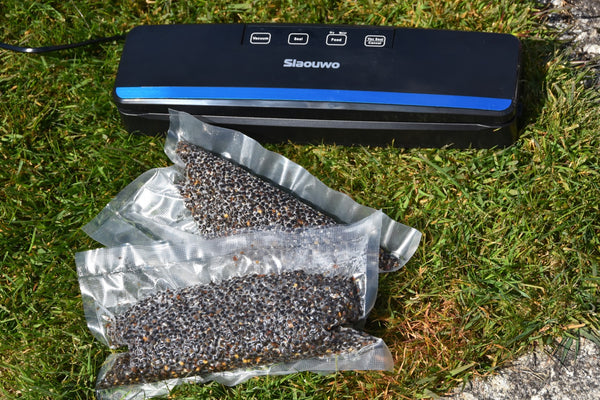 Coloured photo of bait in plastic bag on grass with a sealant machine