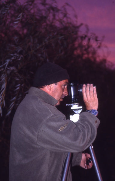 A image of photographer stood in front of camera at night time