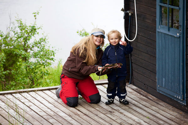 Mum and son holding a fish.