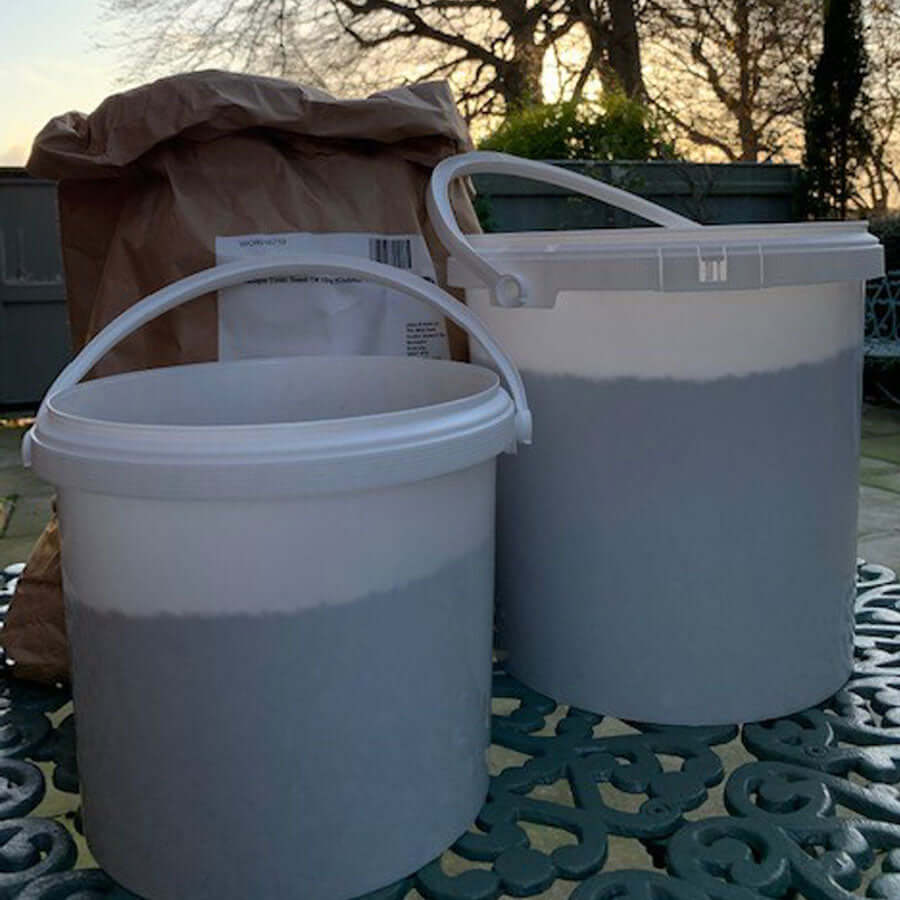 Large White Bird Food Storage Tubs filled with SuperClean bird seed.