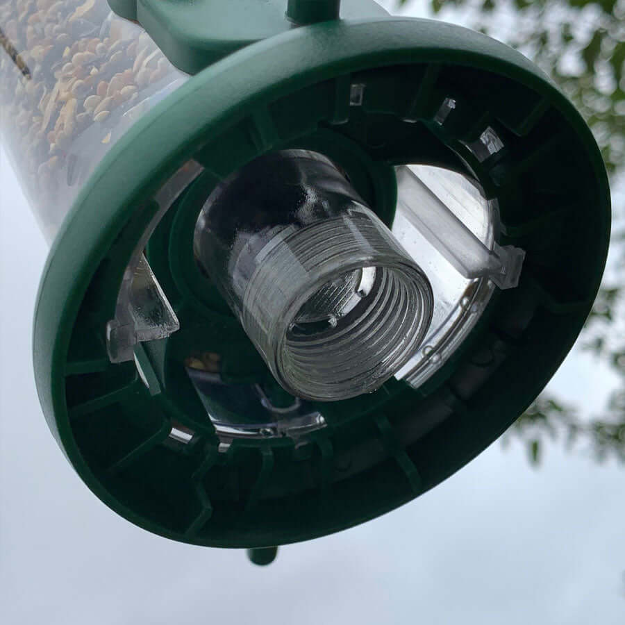 Green plastic based seed feeder that twists off for easy cleaning.